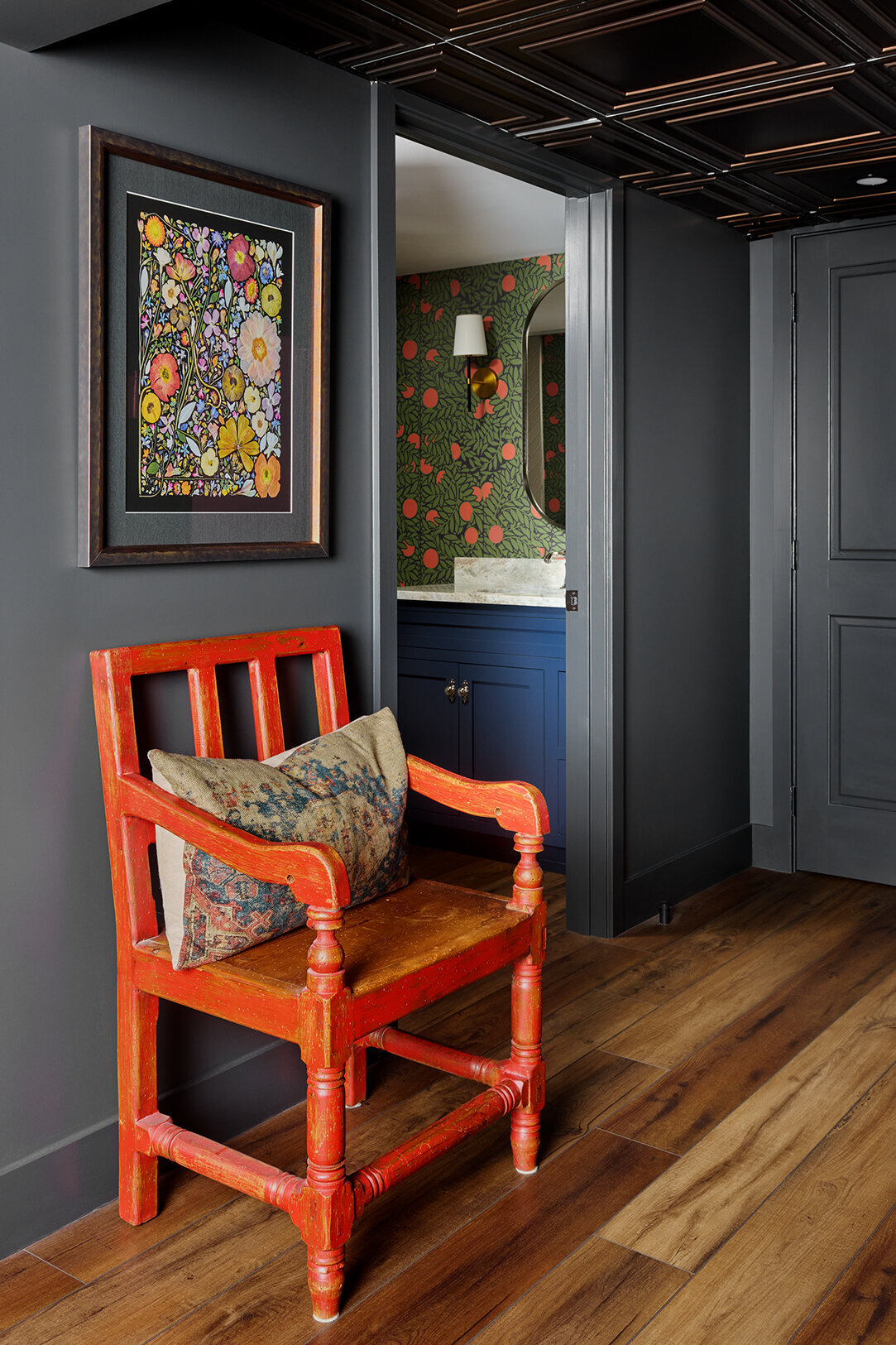 colorful chair in a hallway leading to a bathroom