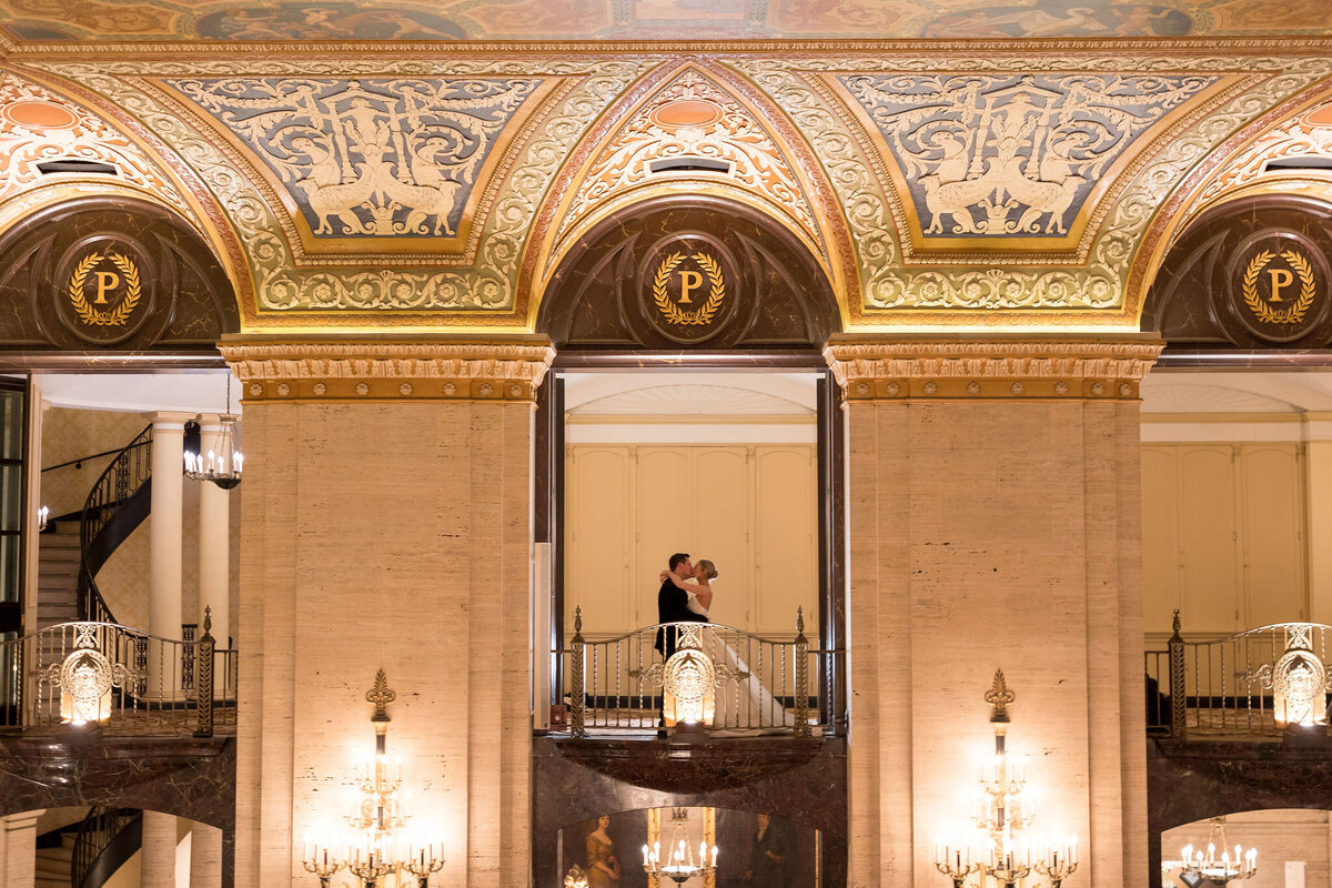 A bridge and groom sharing a hug in the Palmer House Chicago. 