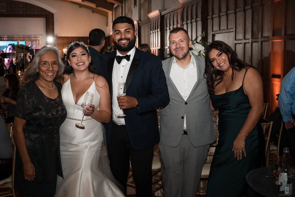 Newlyweds celebrating with champagne and guests at their Union Club Hotel reception.
