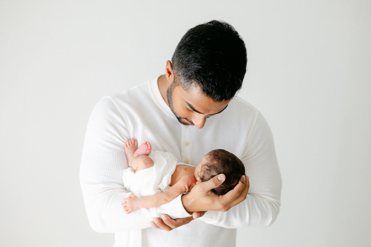 a father holding his newborn baby