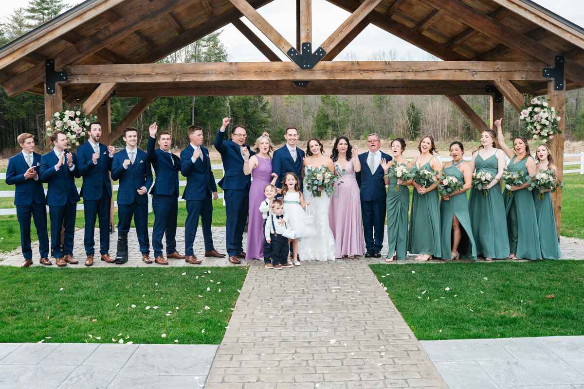 Bride and groom walking hand in hand at their outdoor New England wedding