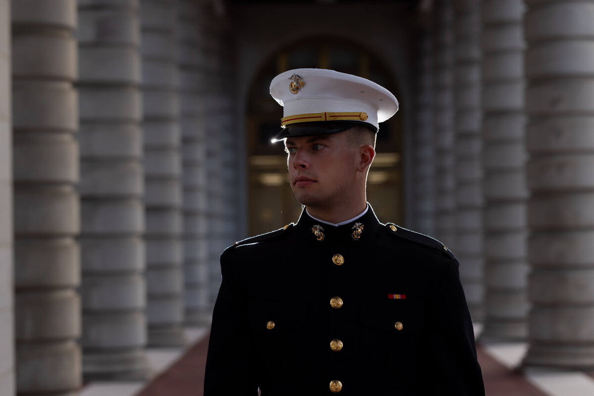 Dramatic backlit portrait by Kelly Eskelsen of marine at Naval Academy.