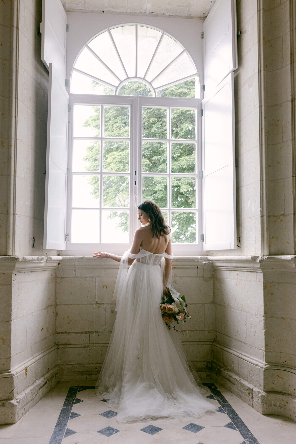 A wedding day photo of a bride in her white wedding dress at Chateau de Jalesnes in France