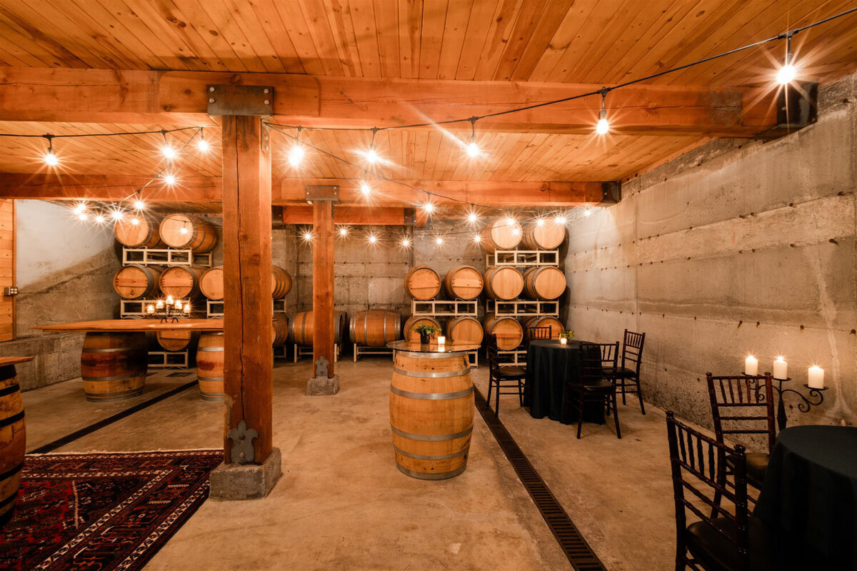 The Barrel room at Chateau Lill full of wine barrels