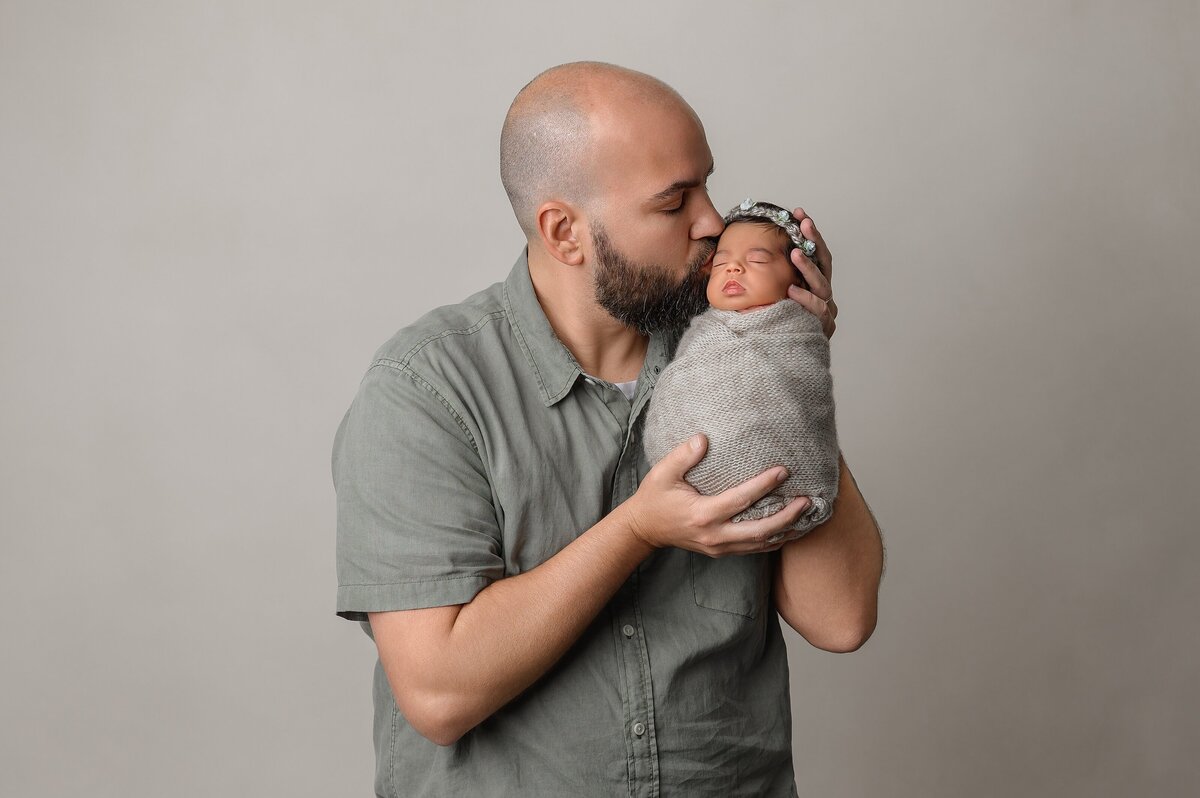 Newborn family session in South Florida studio with dad and baby.