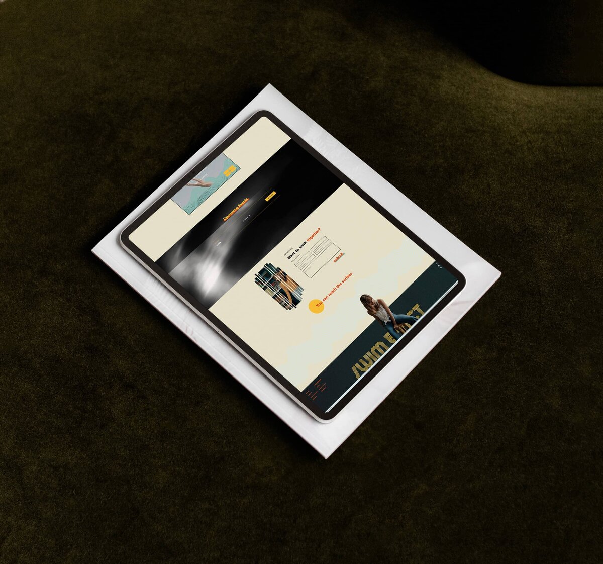 A tablet displaying a webpage rests on top of a white piece of paper on a dark green surface, reflecting the meticulous work of Shreveport web design and small business web designers.