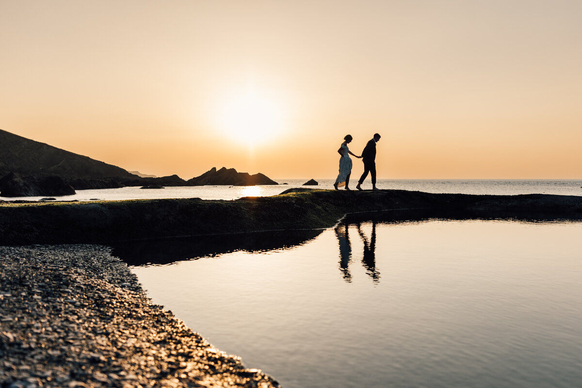 Bride and Groom sunset walk along the UK coast