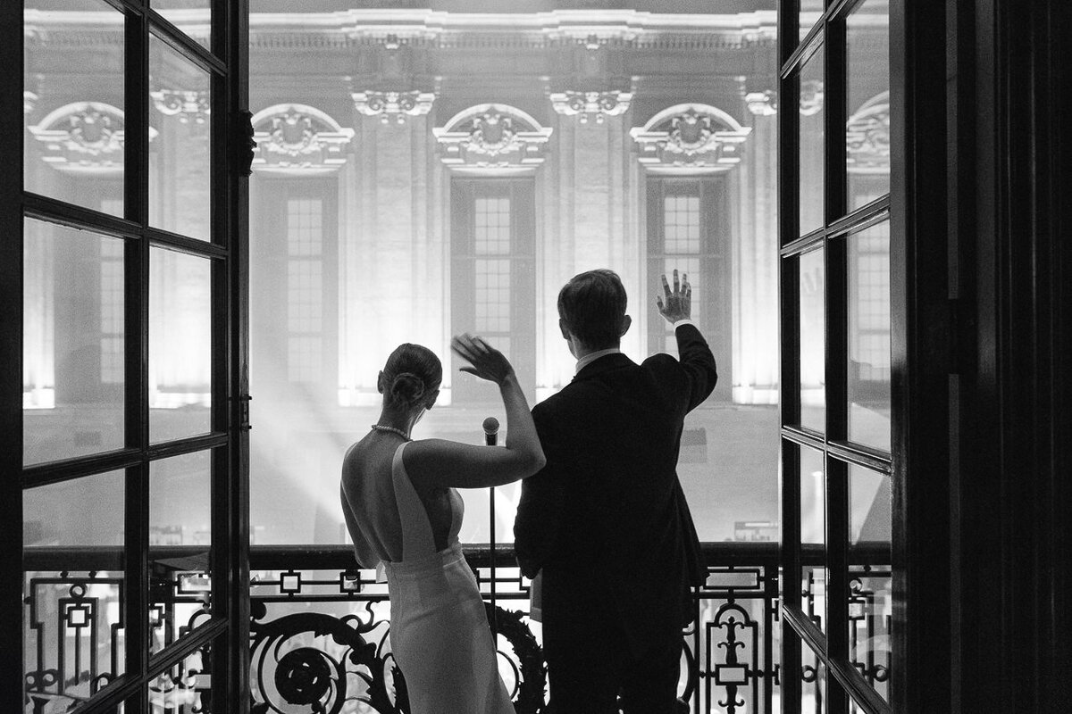 The bride and groom on the balcony of the Théâtre St-James. Montreal wedding.