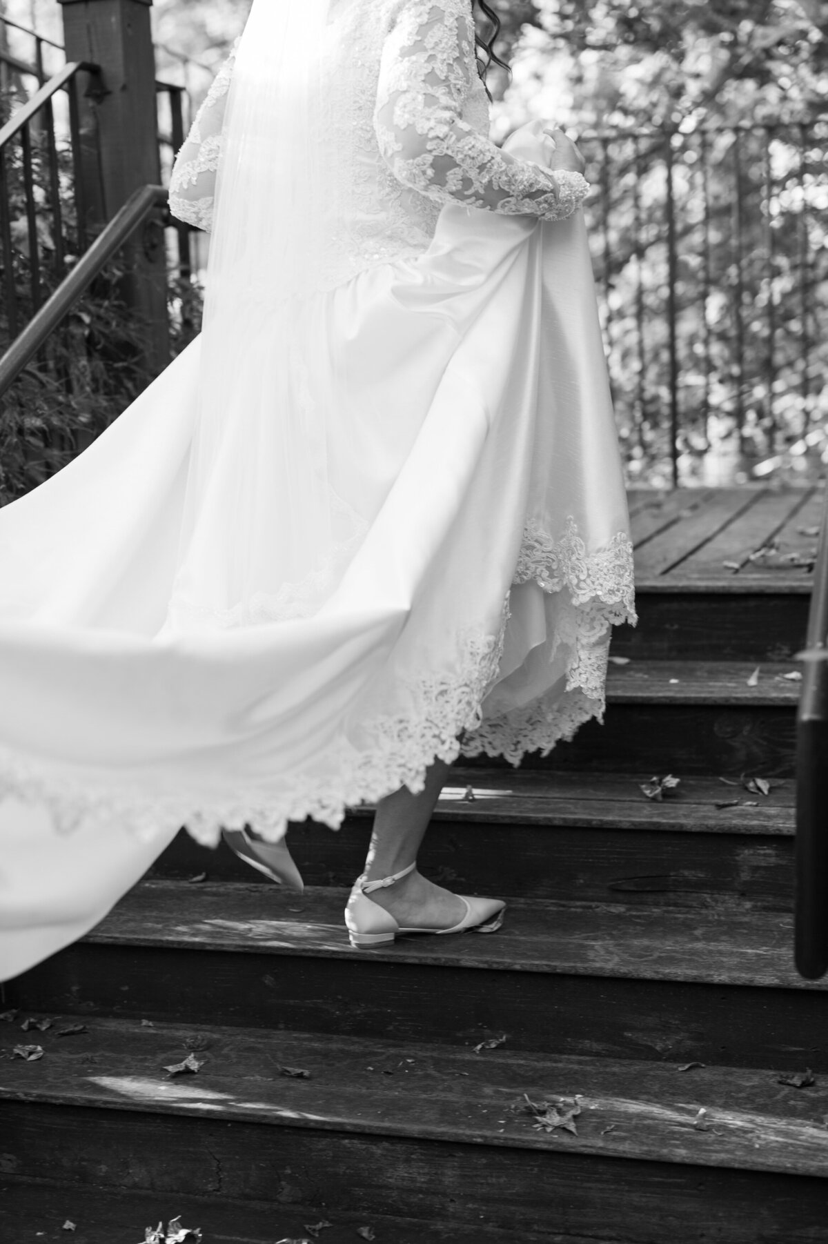 A person in a wedding dress walking up a staircase