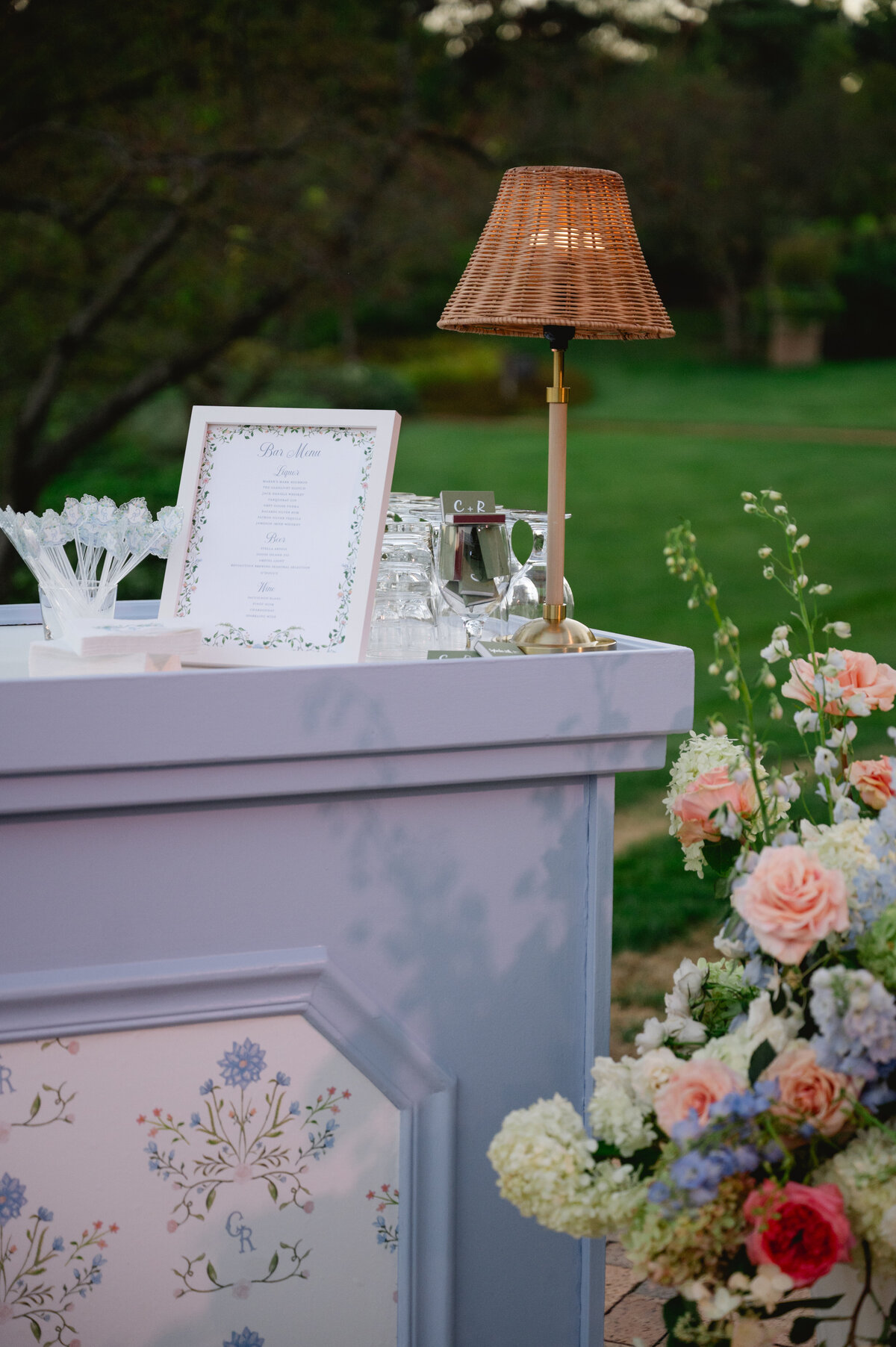 Close-up of the wedding bar decoration with flowers and a lamp