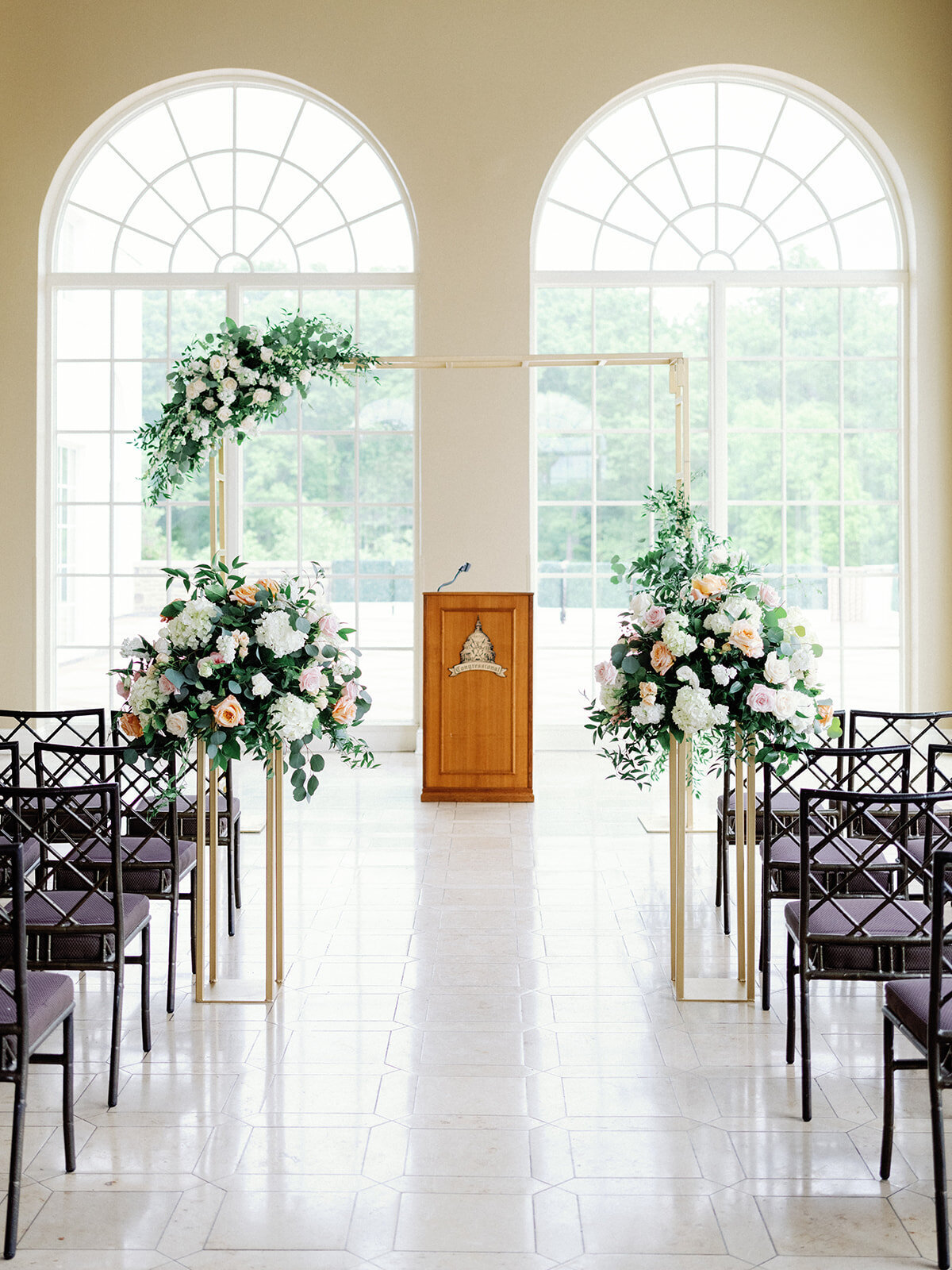 Floral arch with gold on the front of the ceremony space