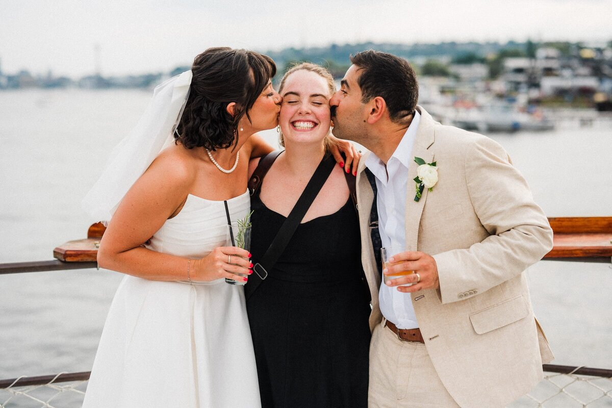 couple kissing a washington elopement photographer on the cheak