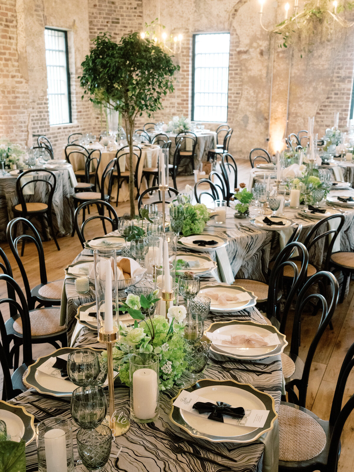 A whimsical dining scene featuring a green textured tablecloth and warm candlelight, providing an inviting and cozy atmosphere perfect for intimate weddings and celebrations.