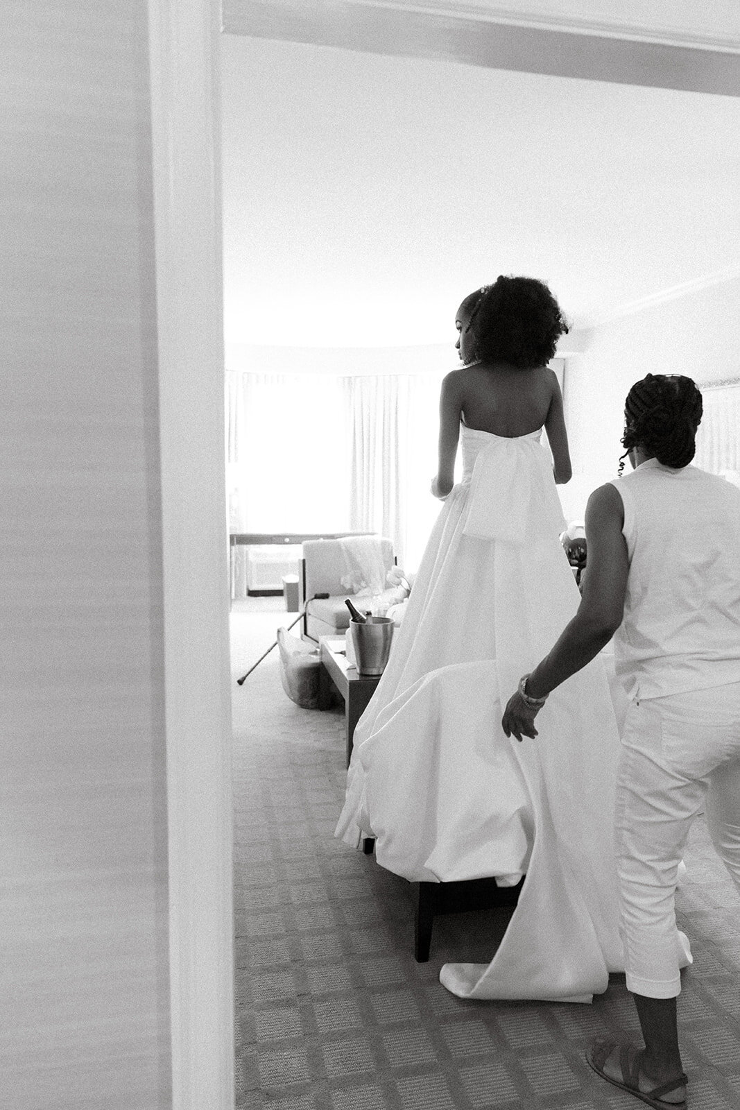 black bride tries on wedding gown 