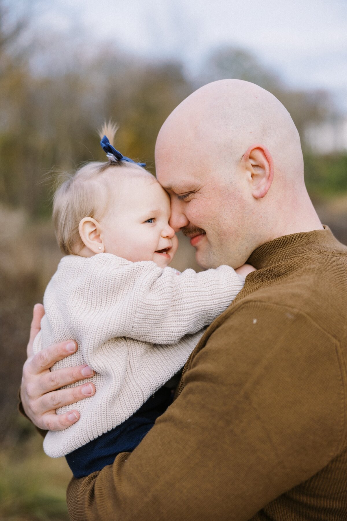 dad nuzzling his baby girl during family photos in Indianapolis