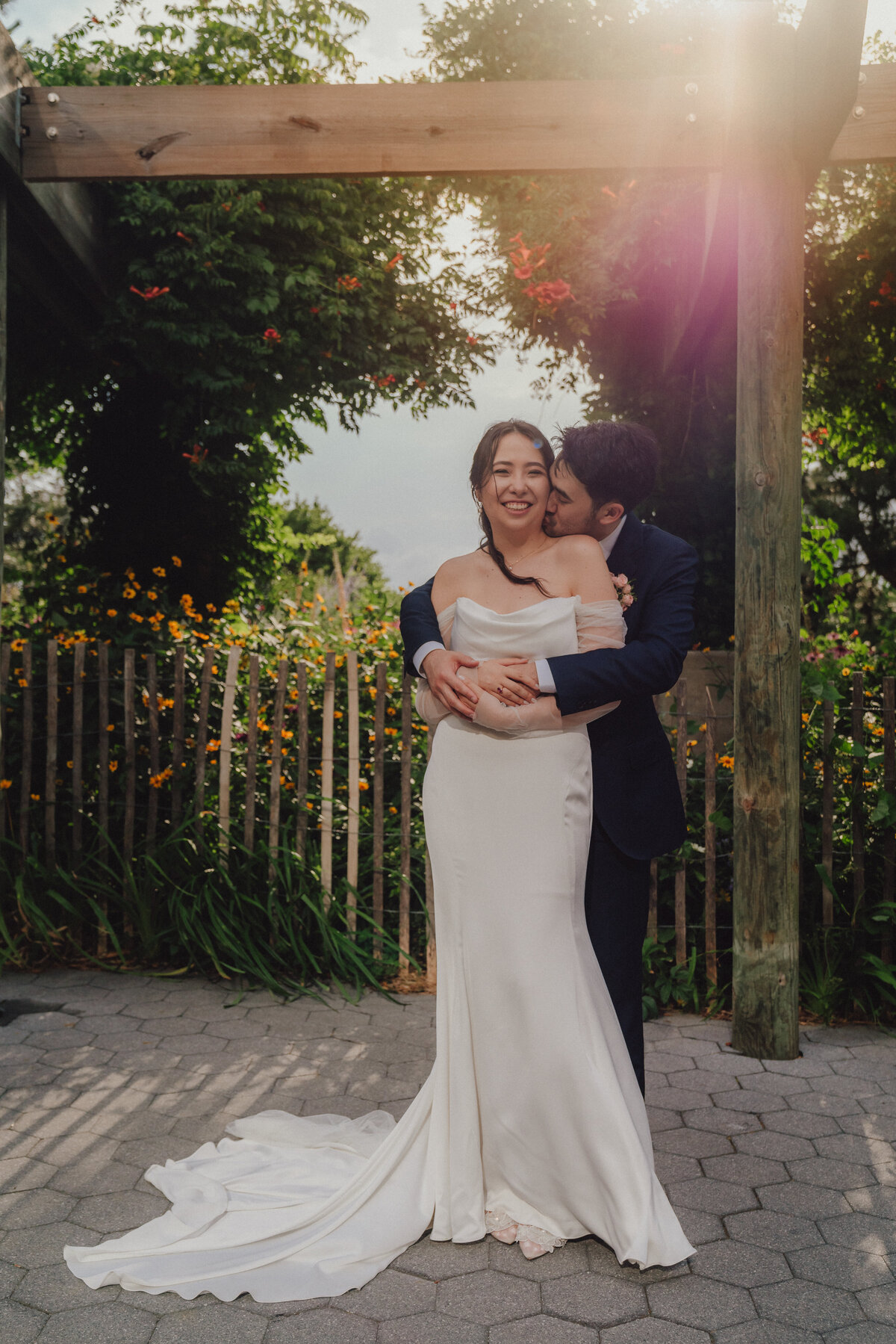 bride and groom hug in battery park, manhattan