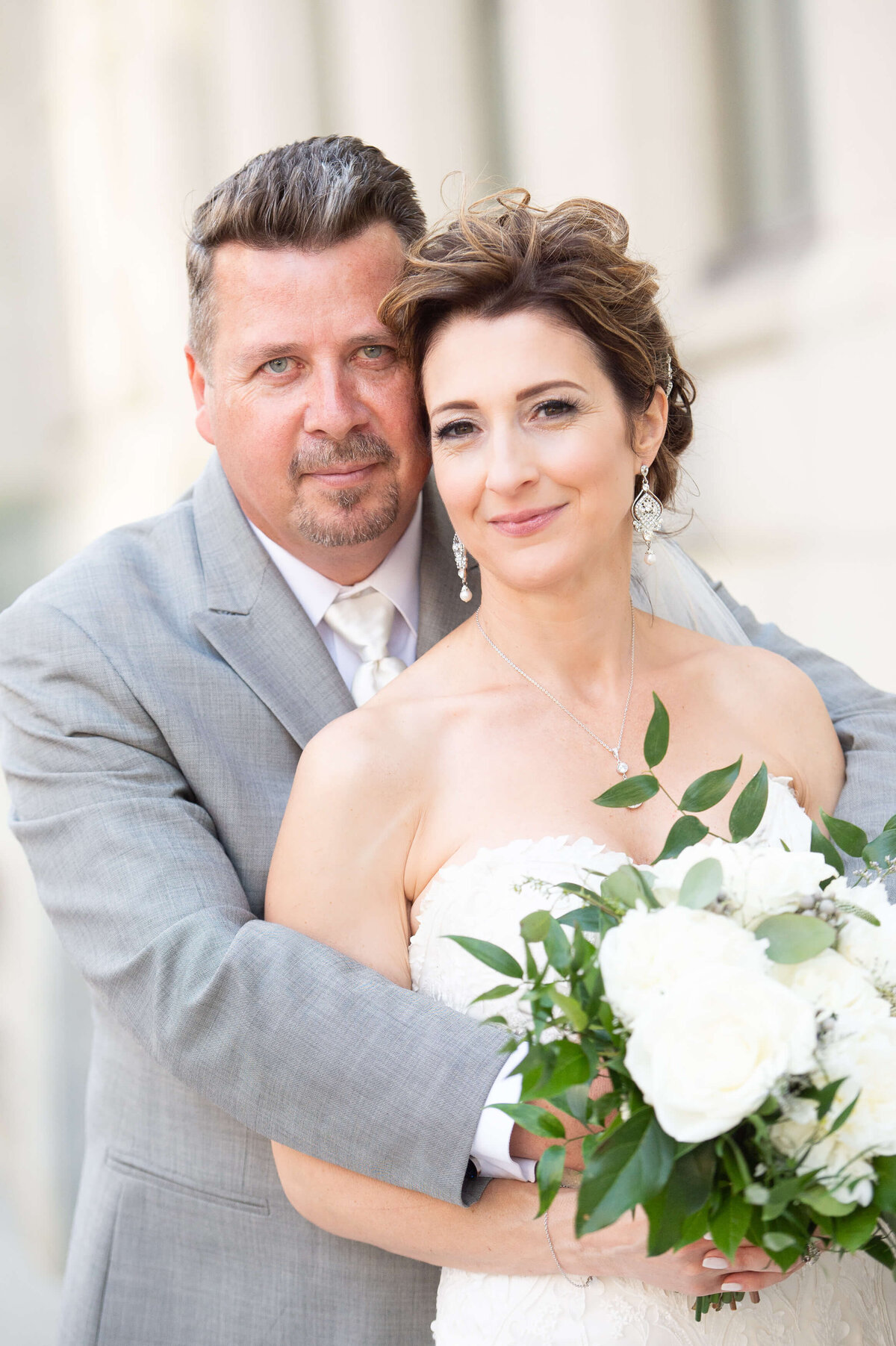a classic portrait of an elegant bride and groom taken outside the Chateau Laurier wedding venue in Ottawa.  Captured by Ottawa wedding photographer JEMMAN Photography