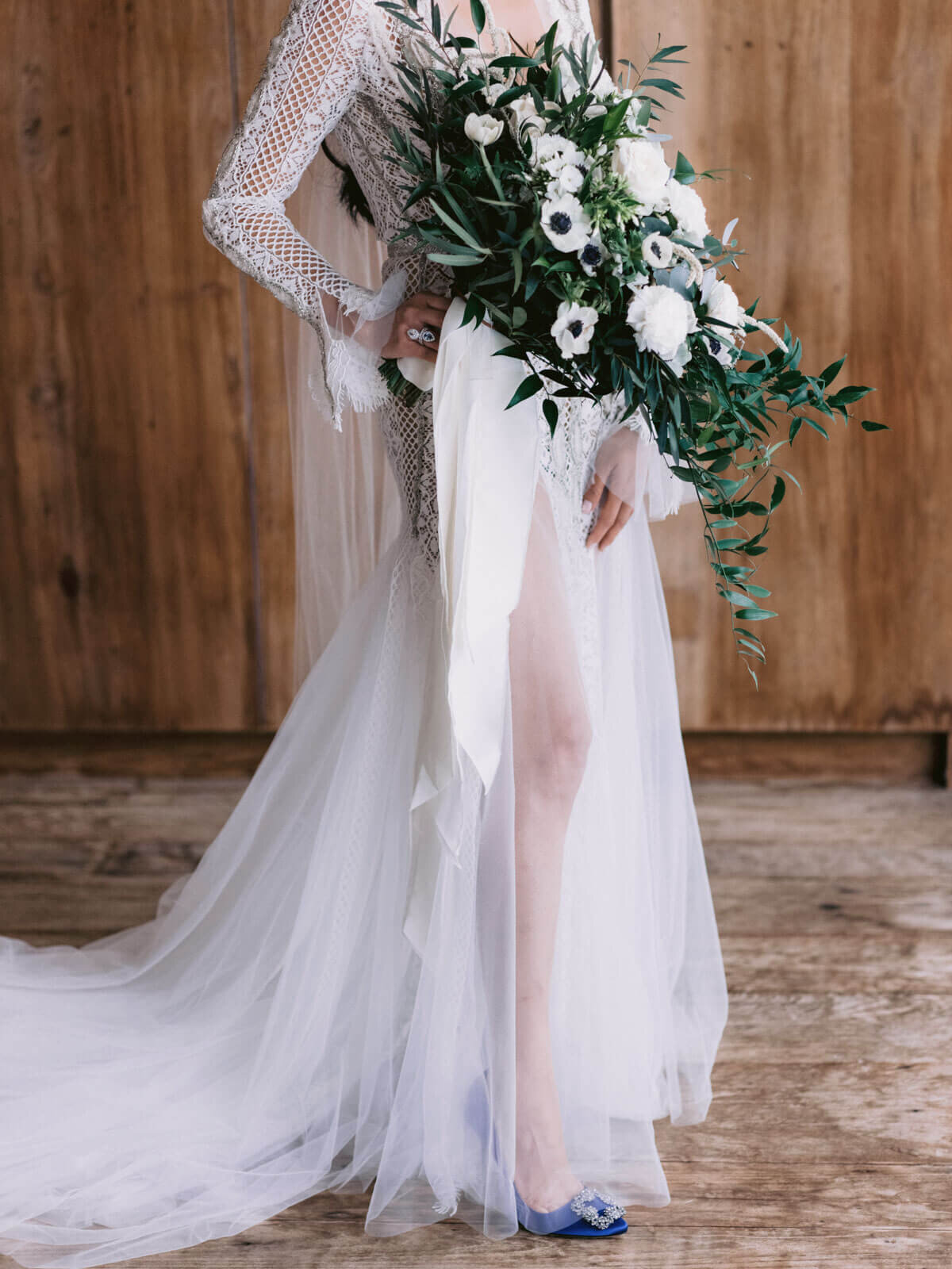 The bride featuring her flower bouquet and legs in her see-through gown in Khayangan Estate, Indonesia. Image by Jenny Fu Studio