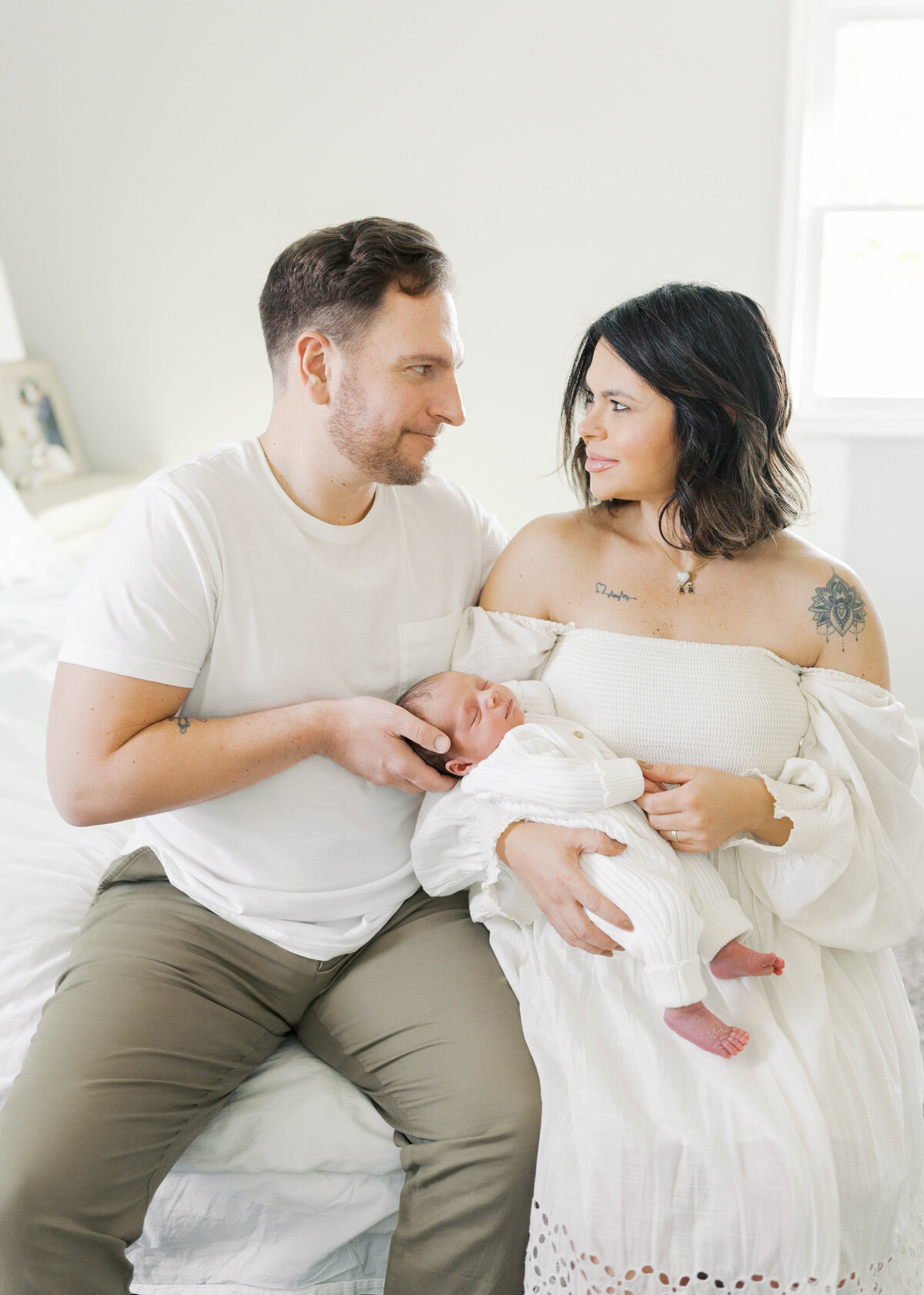mom and dad holding newborn baby during Virginia Beach Newborn session