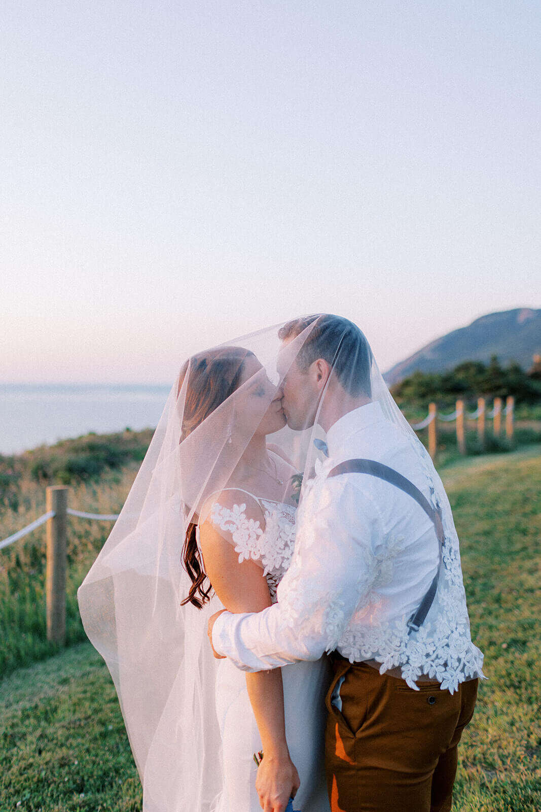 groom-kisses-bride-under-veil