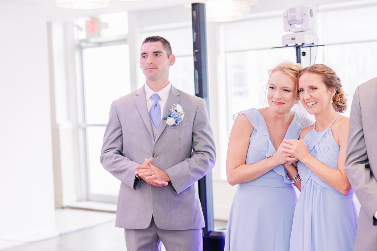 Bridesmaids hugging and smiling representing candid Cape Cod wedding pictures
