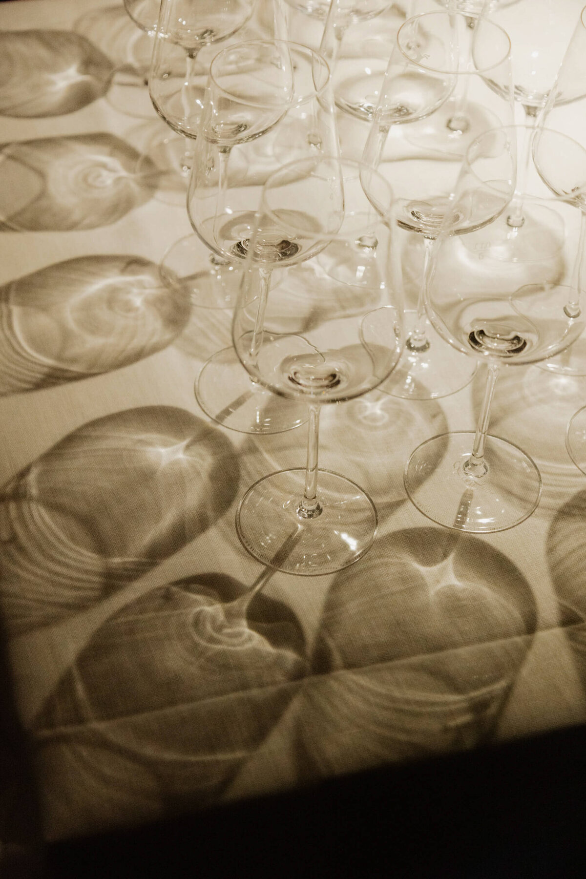 Abstract light reflections on empty champagne glasses by Vienna Photographe