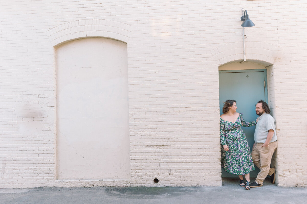 A couple standing in a small doorframe together