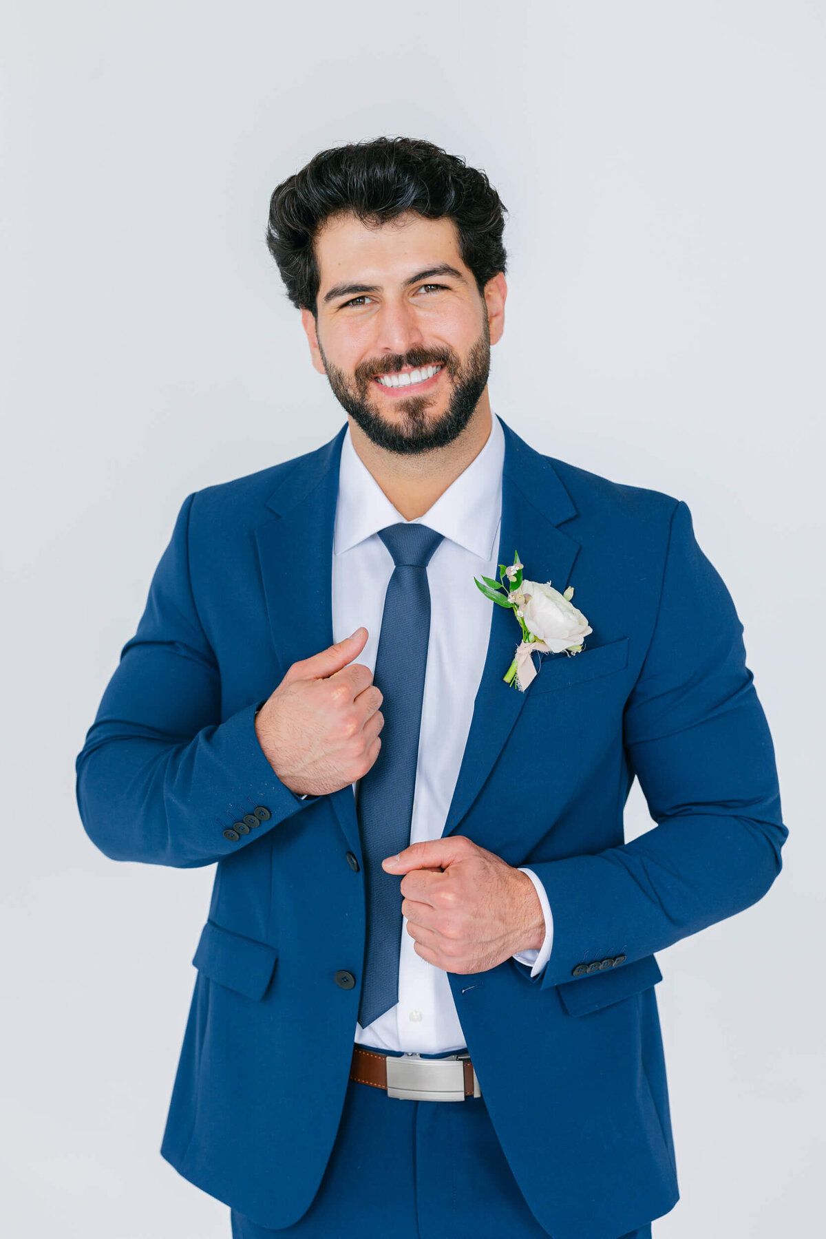 groom holding suit lapel