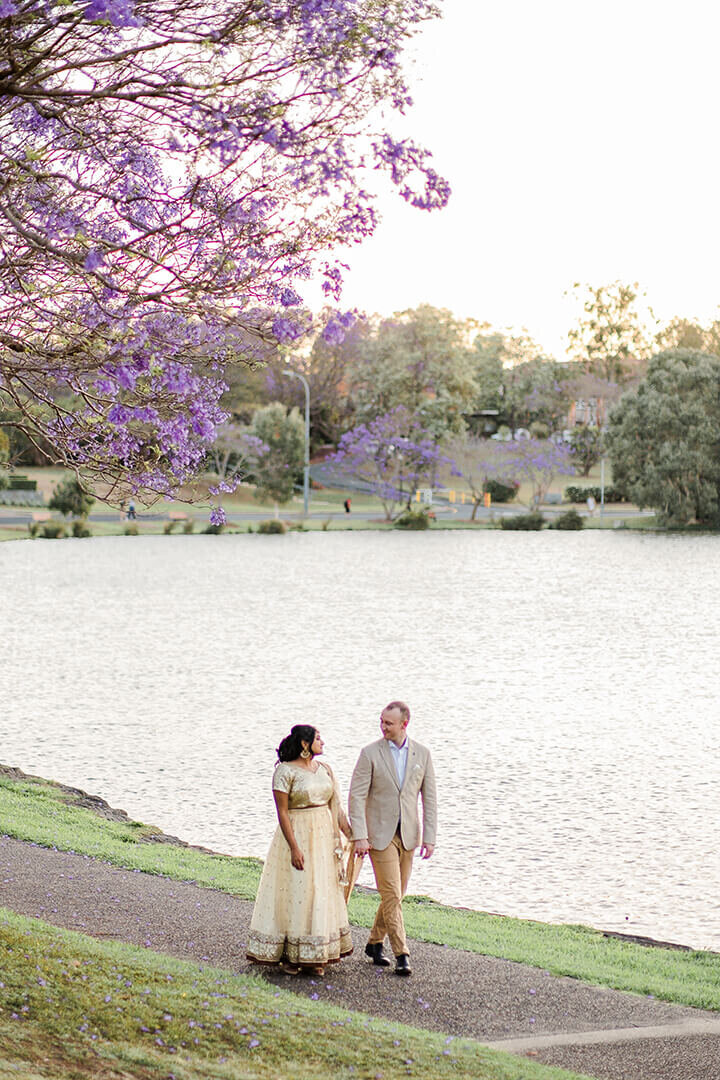 couple walking along UQ lakes during sunset hours in Brisbane QLD