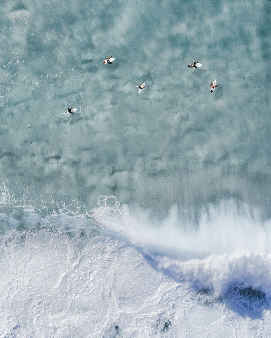 Aerial image of ocean water with four seabirds flying across the frame, used for UNYA pilates sock brand project