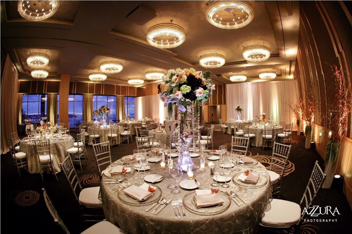 elegant anniversary party at Four Seasons Hotel Seattle with silver and silver Chivari chairs with tall flower arrangements