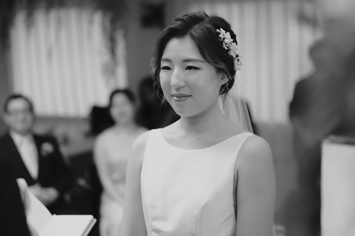 the bride teary eyes while listening to her groom's vow