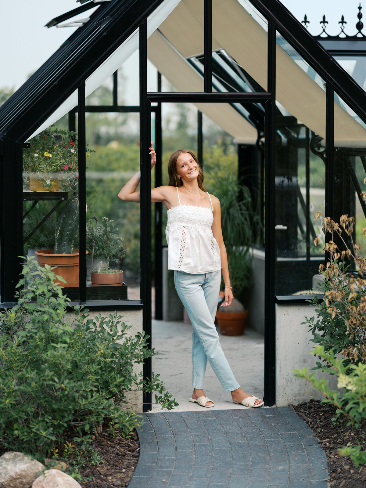 senior-girl-standing-in-greenhouse