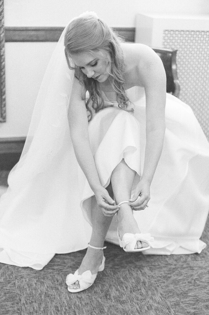 Black and White of Bride Putting Her Shoes On Photo