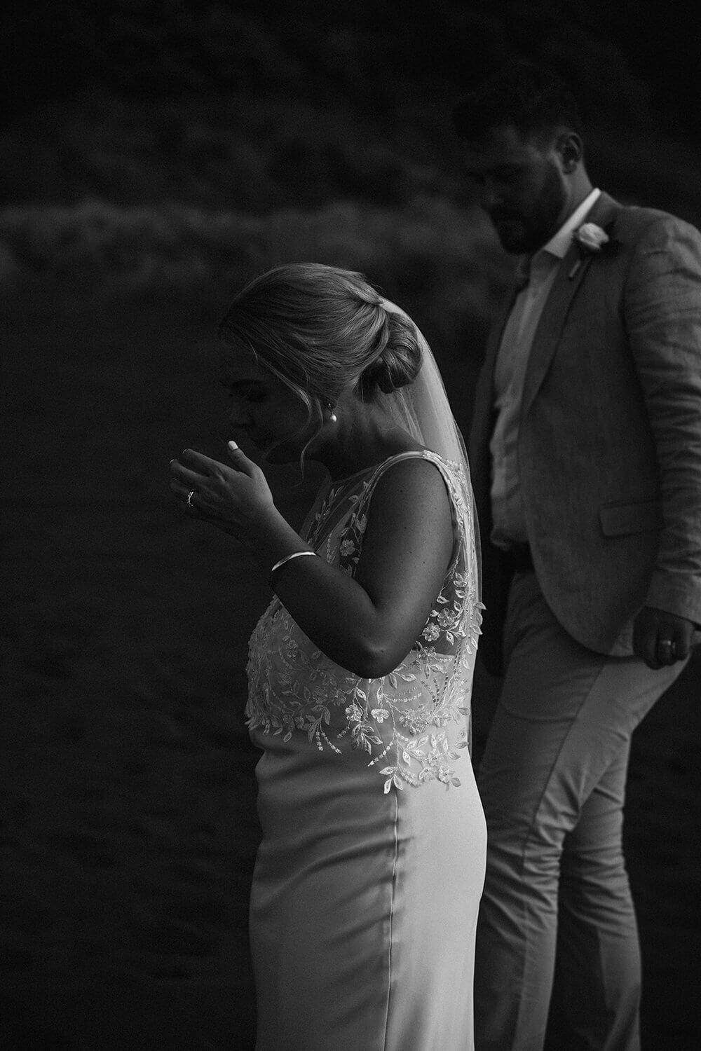 A bride and groom walking side by side while they're photographed by wedding photographer aimee kelly at Ahu Ahu wedding venue