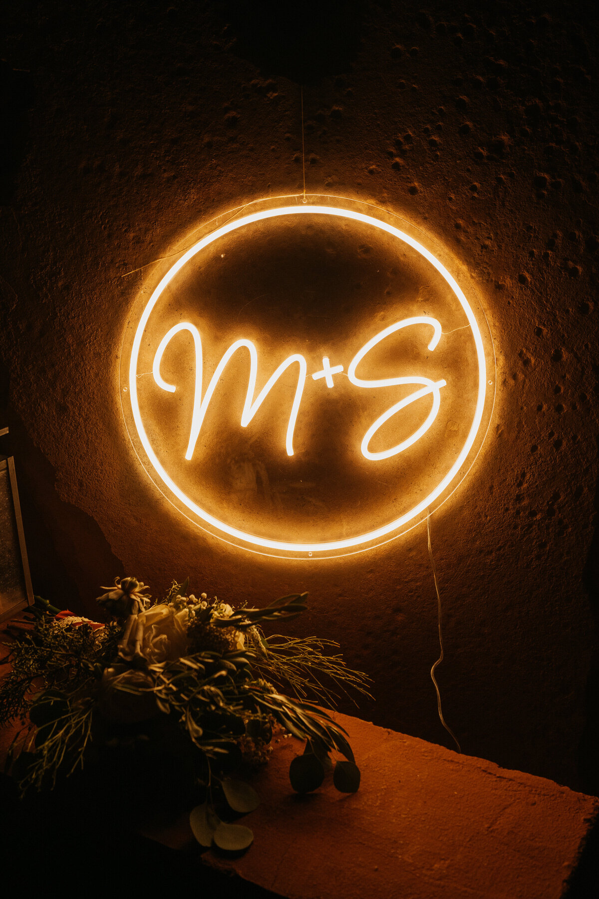 A neon sign that reads "M + S"