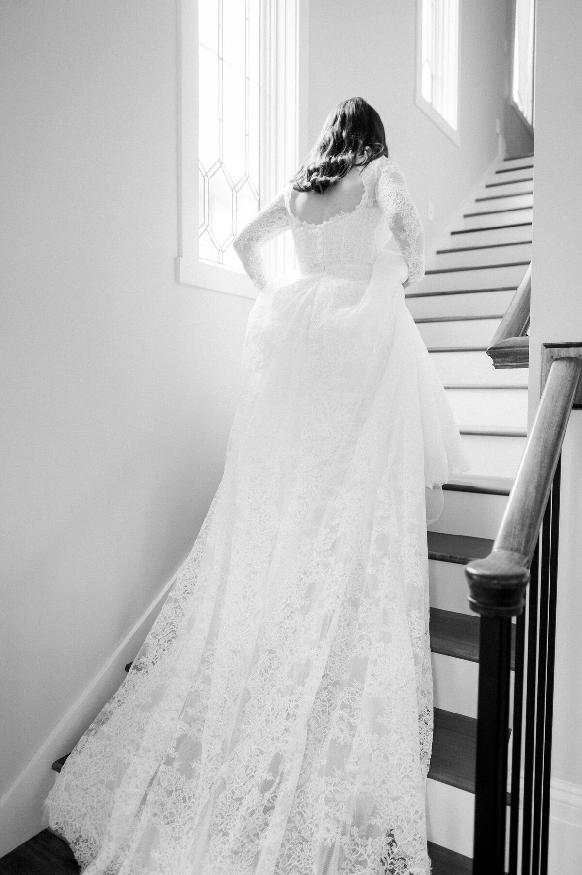 a bride walking up steps in her wedding dress