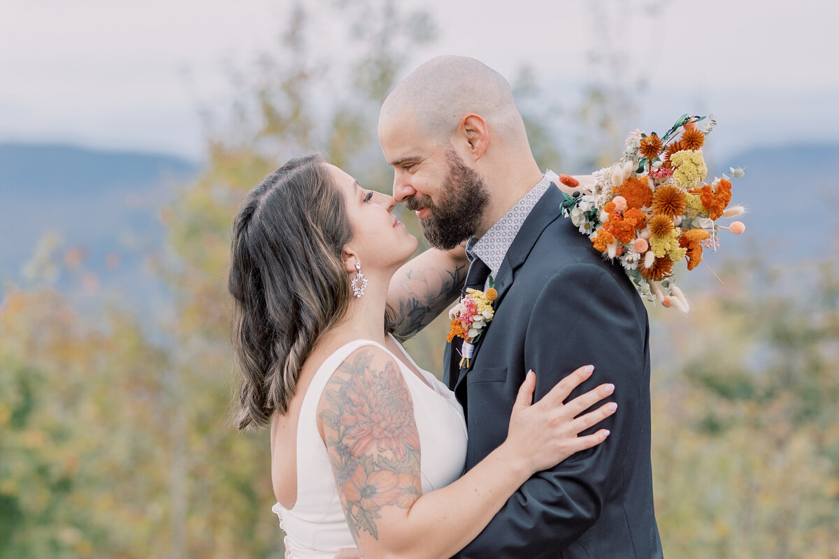 Bride and Groom about to kiss on top of a mountain in the Adirondacks,