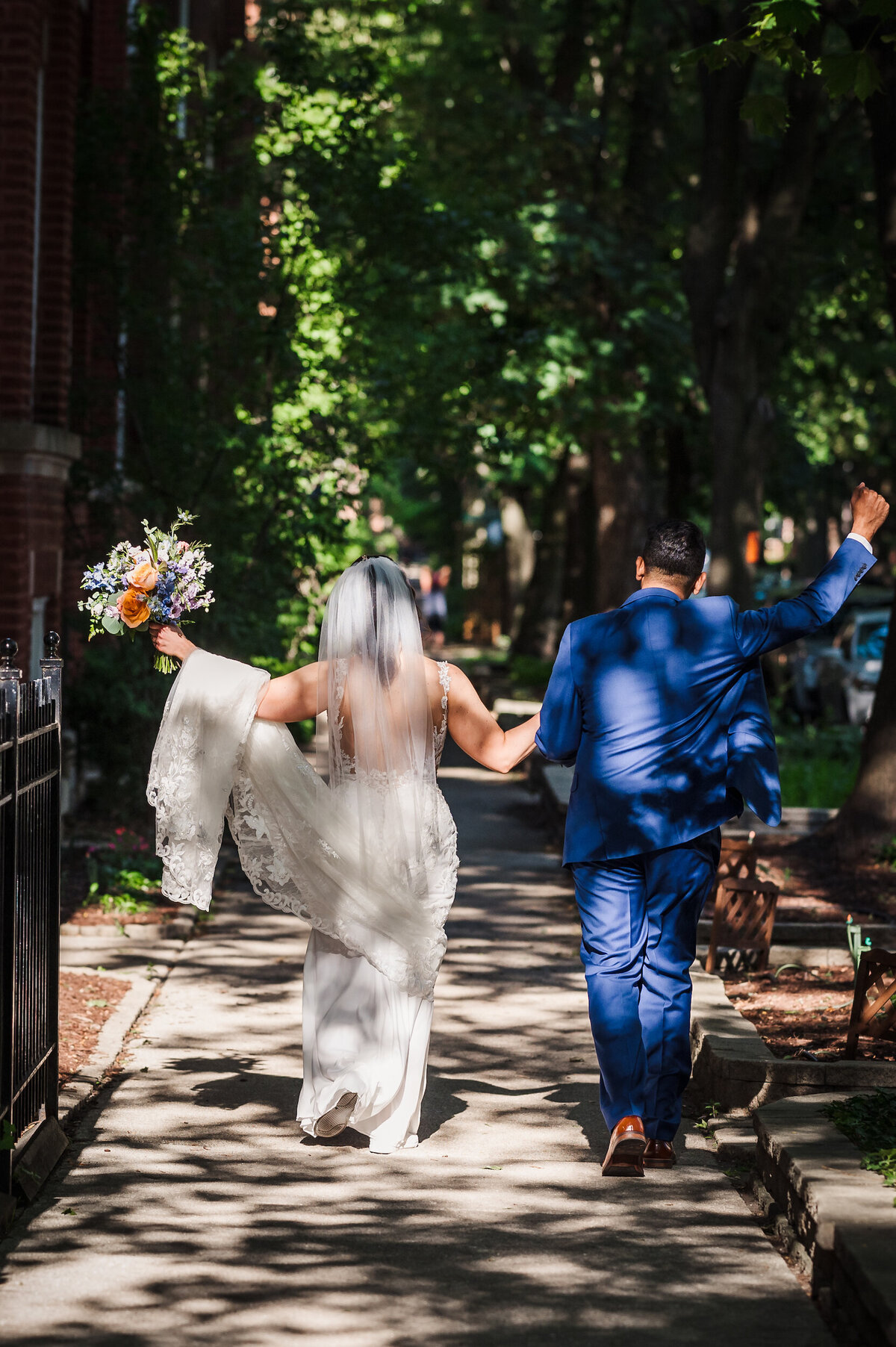 Bride and groom walk down the street in Chicago, Illinois