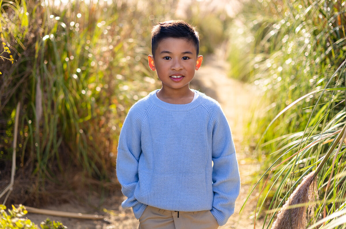 Young boy smiling in a soft blue sweater during Bay Area school photography lifestyle session – Ellobelle Photography
