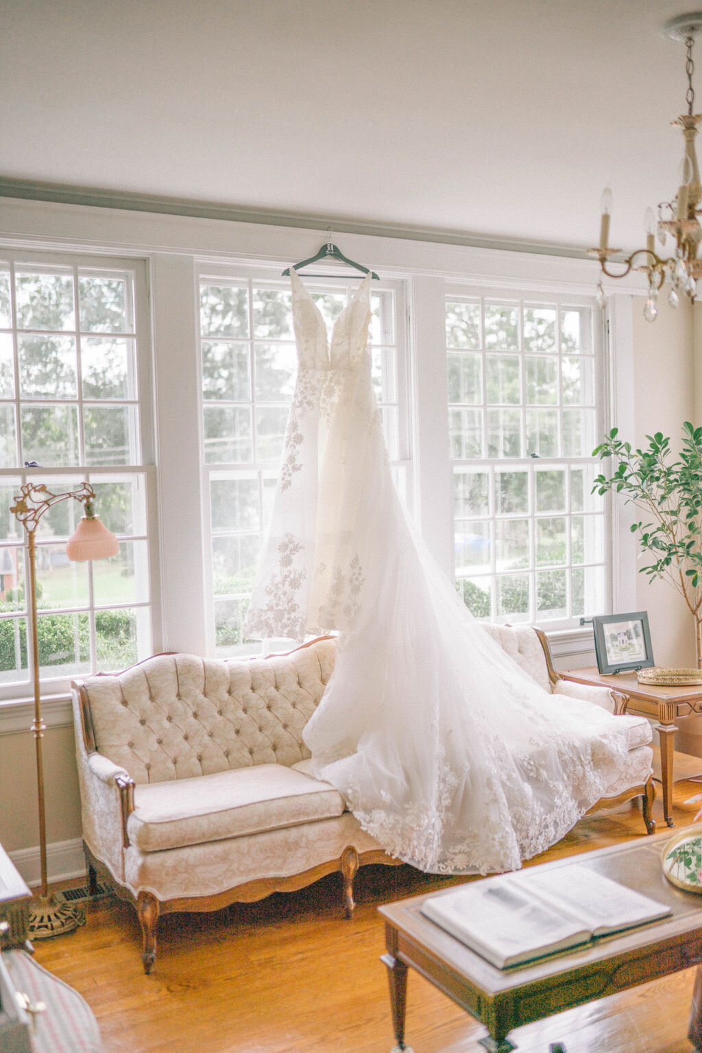 wedding gown hangs in the window of kincaid house in knoxville tennessee
