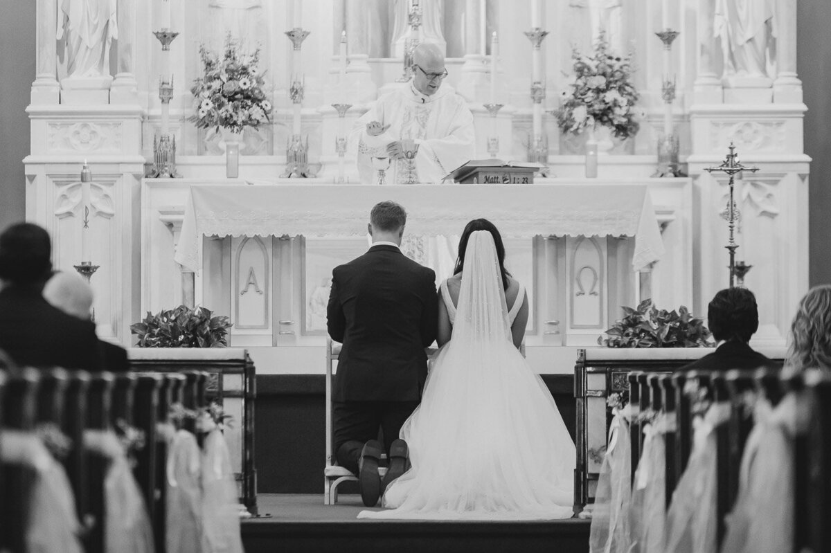 a bride and groom standing at a church altar