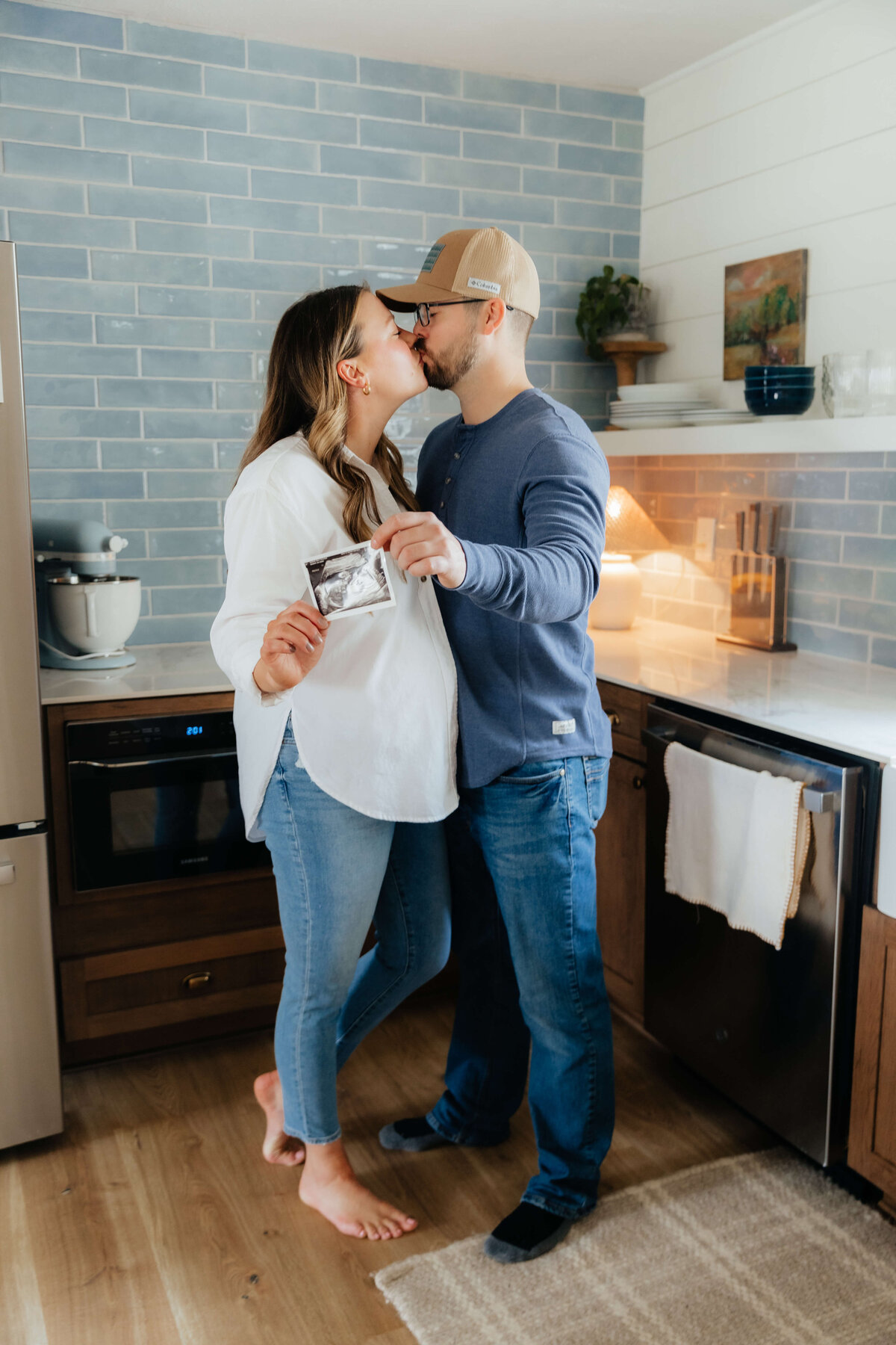 Candid lifestyle maternity photo for Midwest couples announcing their baby, captured in a relaxed and joyful in-home session