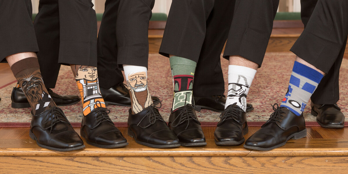 The groom and groomsmen show off their custom Star Wars socks.