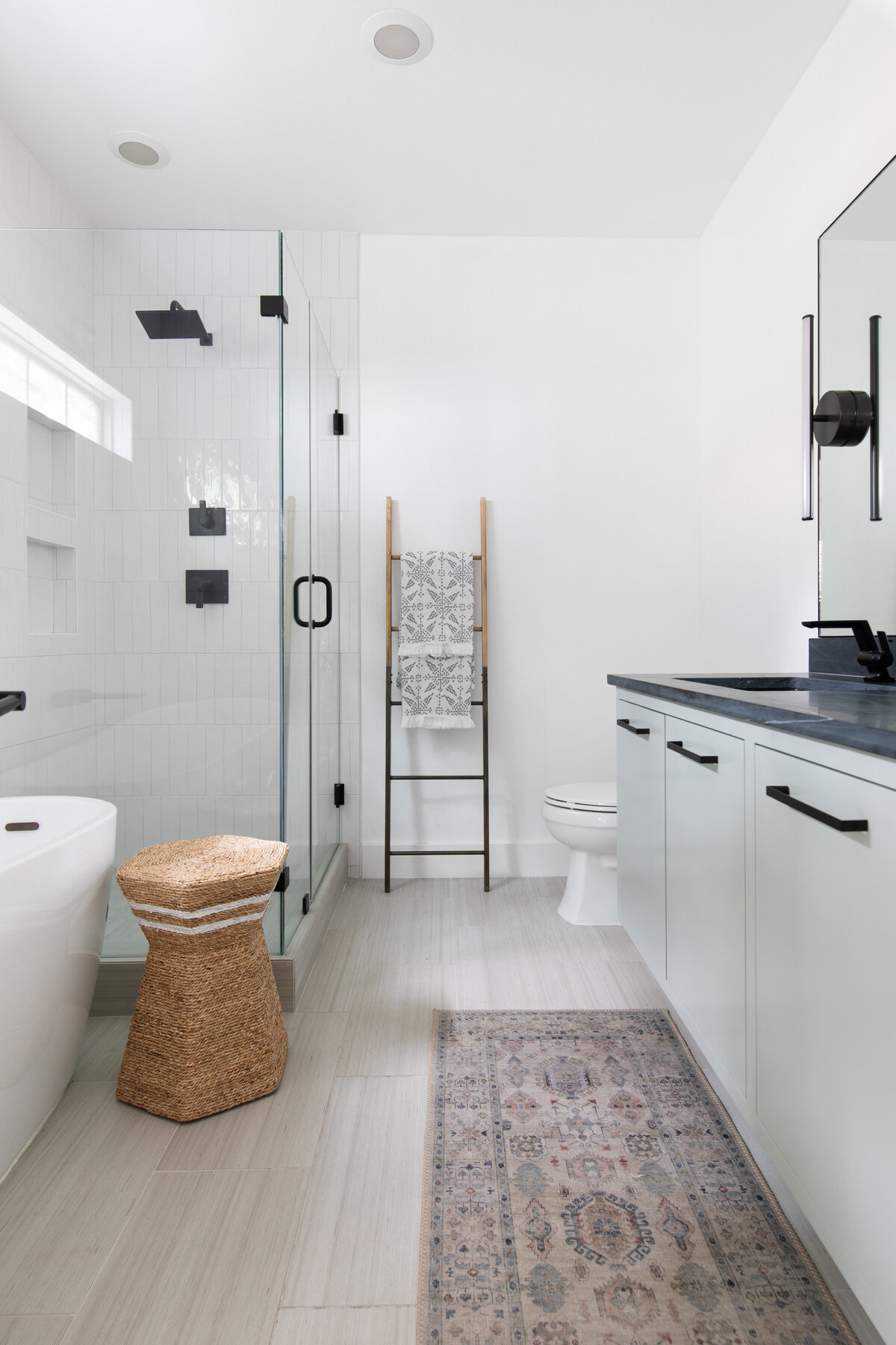 hello-home-sleek-modern-bathroom-design-black-countertops-glass-shower-freestanding-tub-austin-6