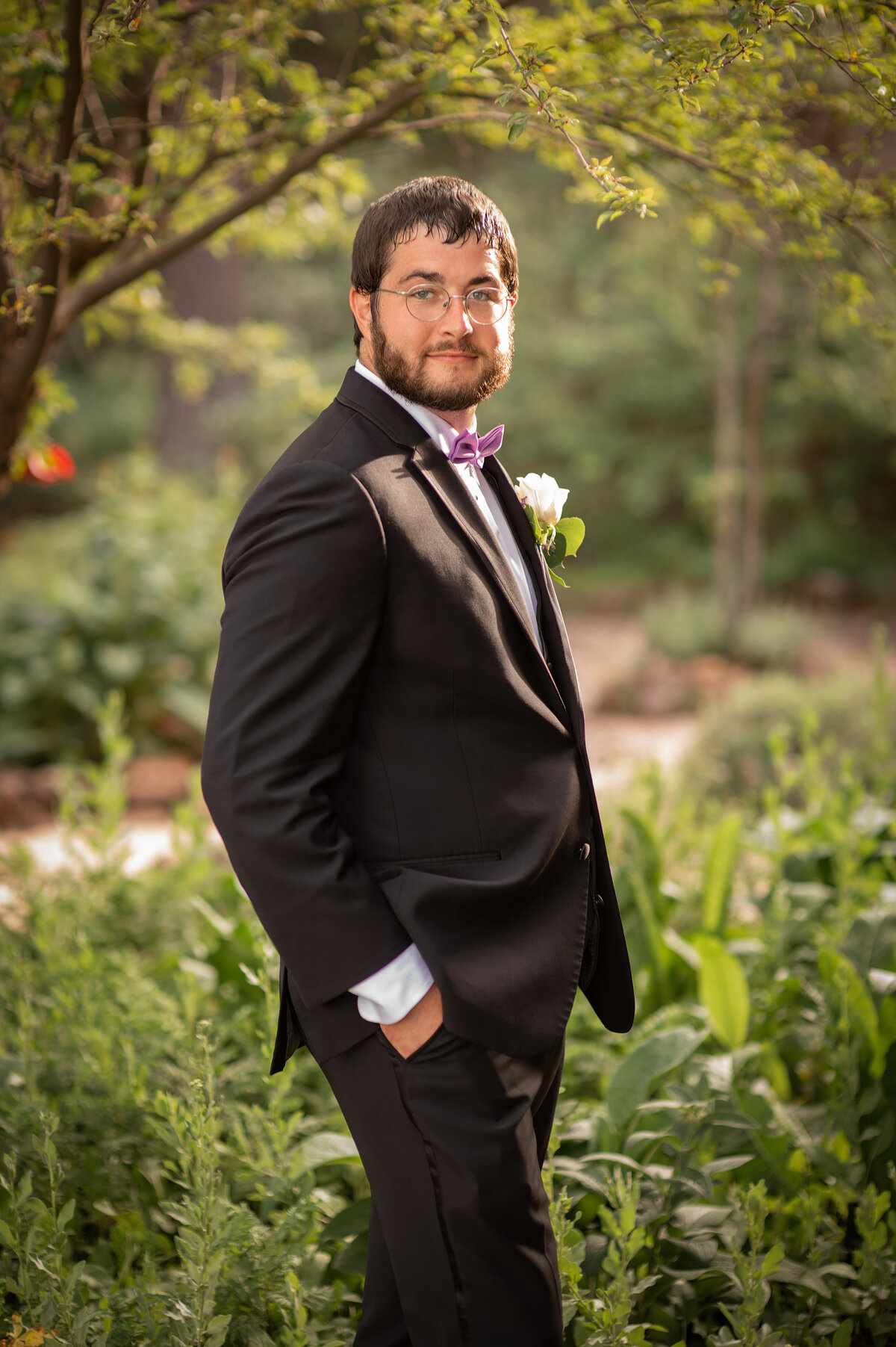 Groom poses for portrait in his wedding tuxedo