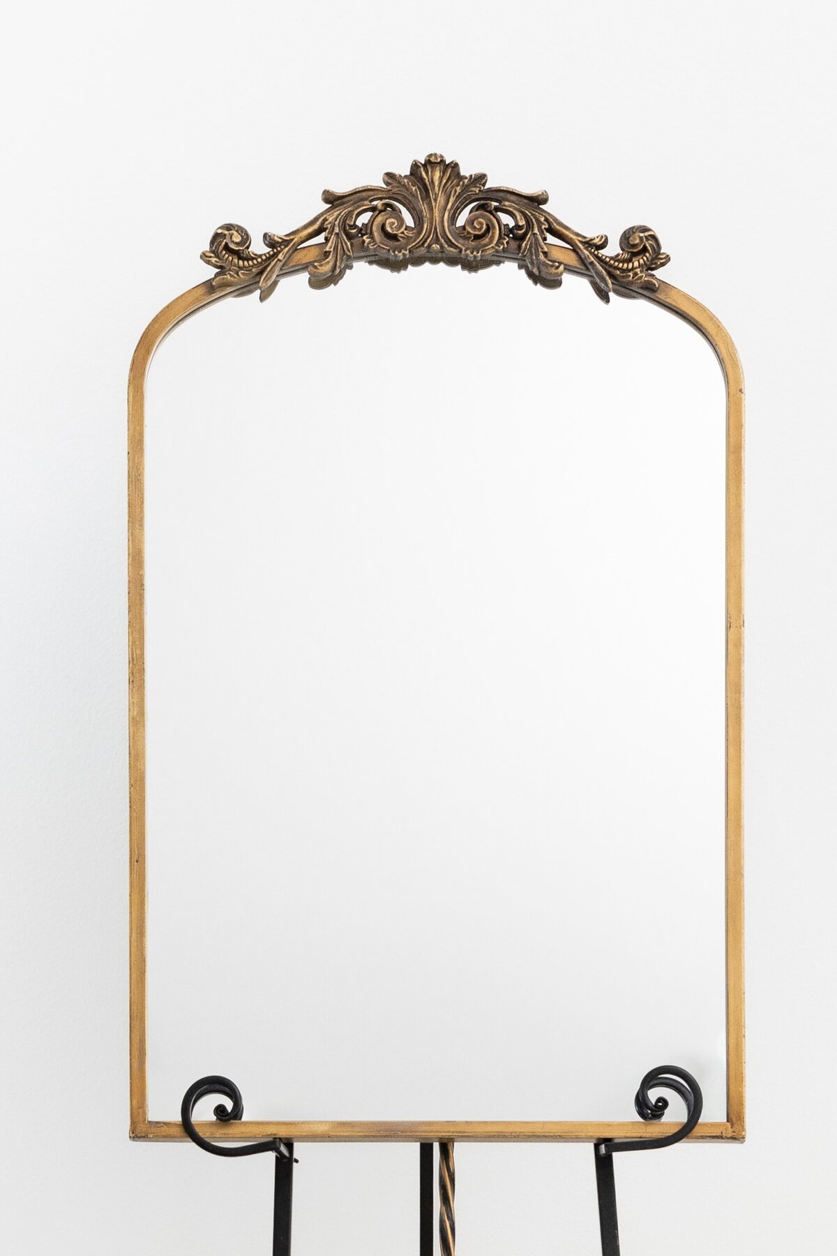 Medium arch mirror with ornate ornament on top