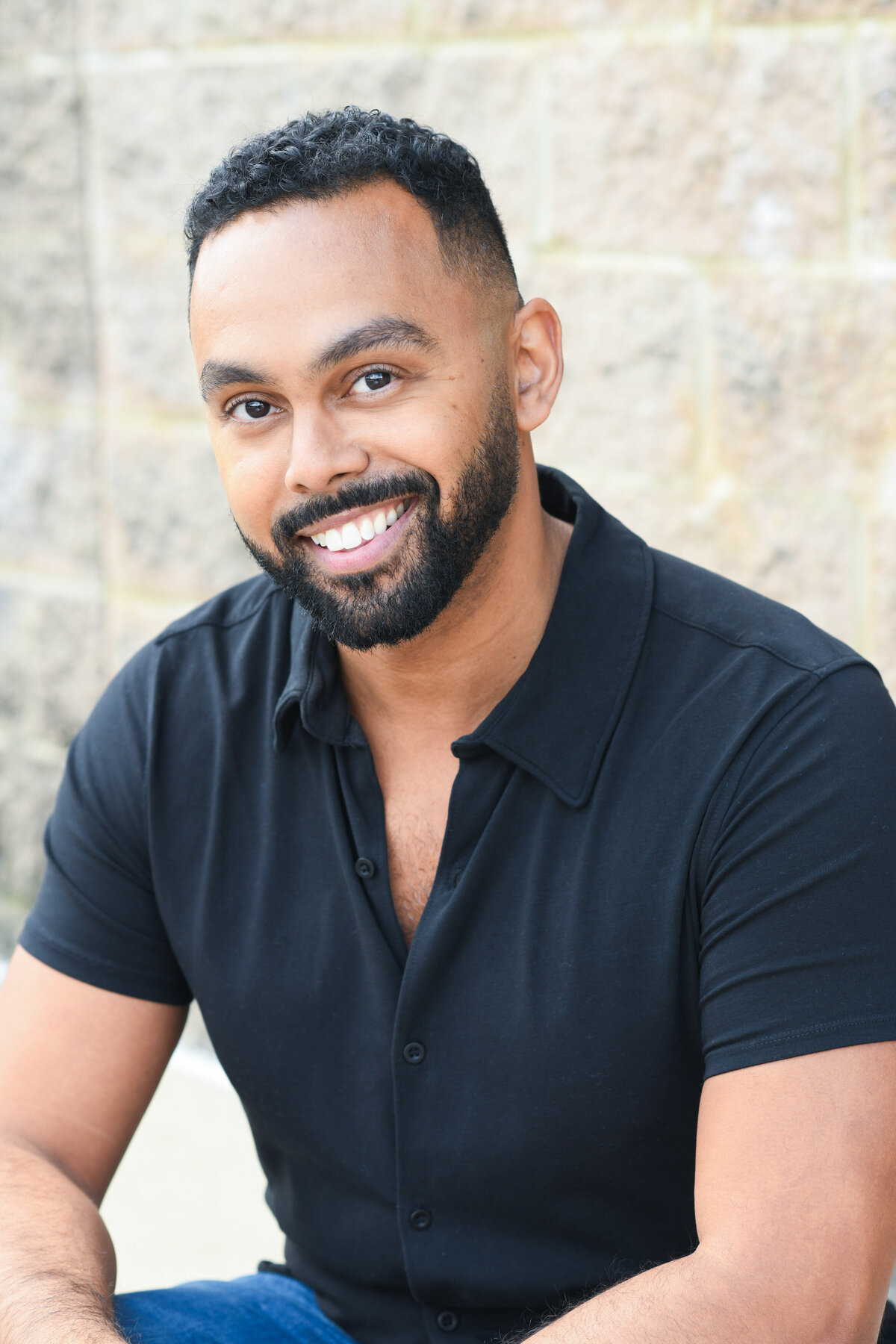 A person sitting down smiling