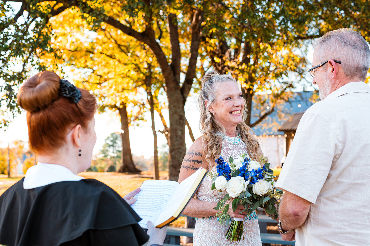 Bride smiling at groom during their vows