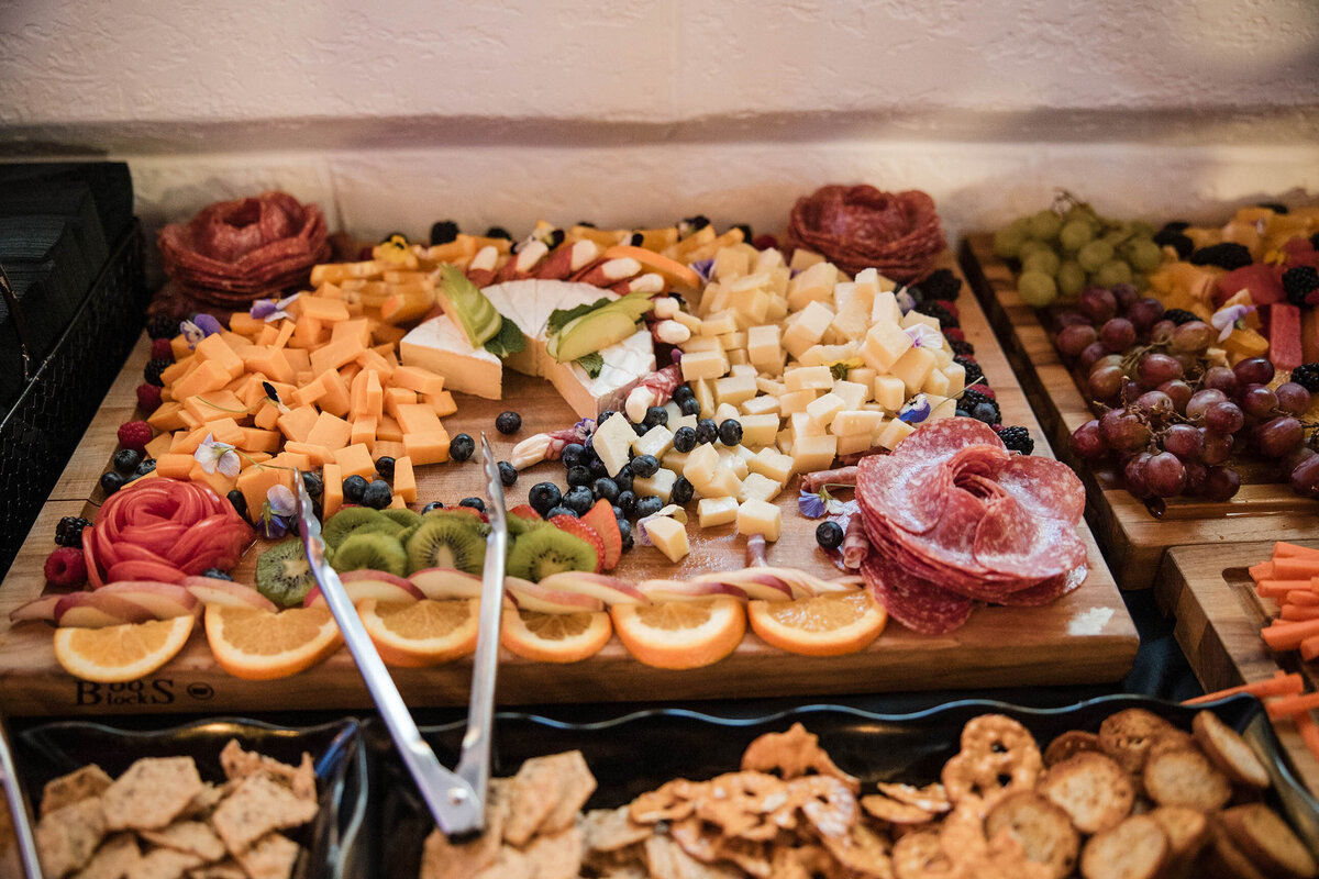 picture of chacuturrie board, fruit, crackers, and cheese.